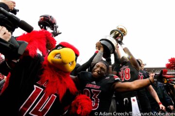Louie the Cardinal, Brandon Radcliff, and Deiontrez Mount 11-29-2014 Louisville vs. Kentucky 2014 Governor's Cup Photo by Adam Creech