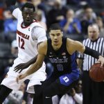 Duke forward Jayson Tatum (0) looks to move past Louisville forward Mangok Mathiang (12) during the quarterfinals of the 2017 New York Life ACC Tournament at the Barclays Center in Brooklyn, N.Y., Thursday, March 9, 2017. (Photo by David Welker, theACC.com)