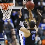Duke forward Jayson Tatum (0) has his shot blocked by Louisville forward Mangok Mathiang (12) during the quarterfinals of the 2017 New York Life ACC Tournament at the Barclays Center in Brooklyn, N.Y., Thursday, March 9, 2017. (Photo by David Welker, theACC.com)