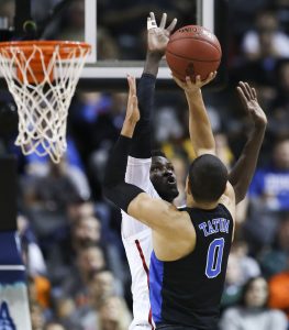 Duke forward Jayson Tatum (0) has his shot blocked by Louisville forward Mangok Mathiang (12) during the quarterfinals of the 2017 New York Life ACC Tournament at the Barclays Center in Brooklyn, N.Y., Thursday, March 9, 2017. (Photo by David Welker, theACC.com)